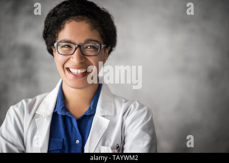 Scientist examining a sample through a microscope. Stock Photo