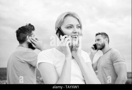 The easiest way to communicate. Mobile phone users. Group of friends talking on cell phones. Modern people with smartphones outdoor. People and technology. Using mobile communication technology. Stock Photo