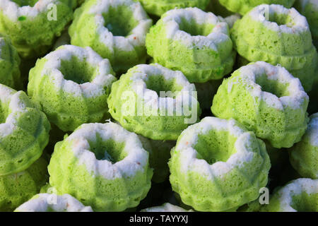 Delicious agreen colored Malaysian home cooked local cakes sold at street market stall in Kota Kinabalu Sabah. Stock Photo