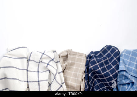Pile of linen kitchen towels on  white background with place for text, top view Stock Photo