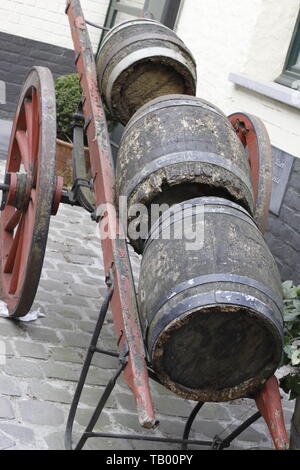 image showing three old wooden wine barrels placed onto an old wooden hand cart Stock Photo