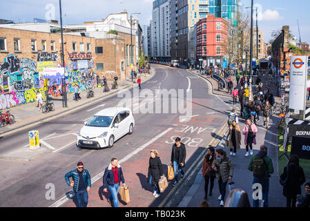 Shoreditch, London, England, UK - April 2019: People walking on Bethnal Green Road near Shoreditch high street station and BOXPARK in Shoreditch Stock Photo