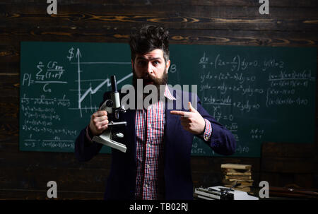 Professional tutors are experts in their academic content. E-learning. Hipster is solving math exam. Mentor needs to have love for how he works Stock Photo