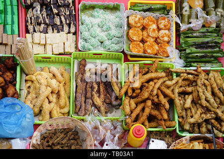 Variety of delicious and colorful Malaysian home cooked local cakes or 'kueh' sold at street market stall in Kota Kinabalu Sabah from top angle view. Stock Photo