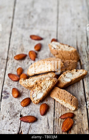 Fresh homemade Italian cookies cantuccini heap and almond nuts on ructic wooden table background. Stock Photo