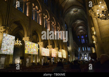 Paris/France - December 8, 2015: Beautiful internal view to the central nave of Notre-Dame Cathedral decorated with paintings for Christmas. Stock Photo