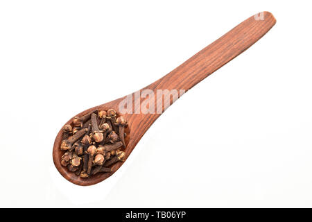 clove buds in wooden spoon isolated on white background Stock Photo