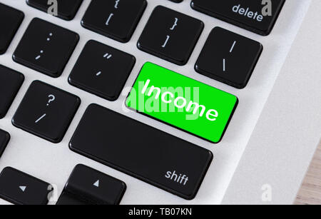 Income word on green computer keyboard button Stock Photo