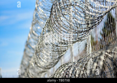 Barbed wire in prison, protecting prisoners from escaping. Stock Photo