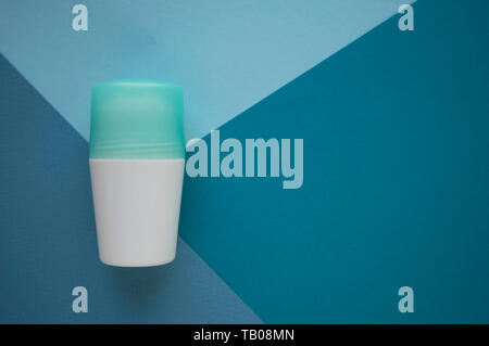 Deodorant or antiperspirant isolated on blue background with copy space. Different tones of blue colors. Body care concept. Stock Photo