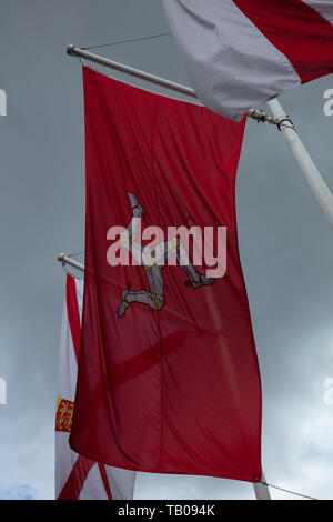 The flag of the Isle of Man flying in the wind at Parliament Square, London, England UK in celebration of Crown Dependencies and Overseas Territories. Stock Photo