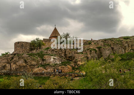 Khor Virap fortress with the visible dome of the Church of the blessed virgin on a rocky hill in the Ararat valley against the darkened sky Stock Photo