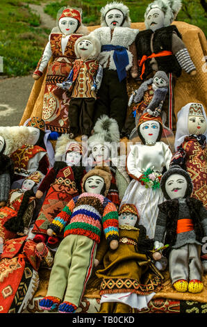 Sunday street trade of rag dolls in national Armenian costumes at the entrance to the medieval fortress of Khor Virap Stock Photo