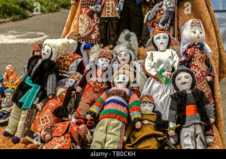 Souvenirs for tourists at the street fair, trade rag dolls in national Armenian costumes at the entrance to the medieval fortress of Khor Virap Stock Photo