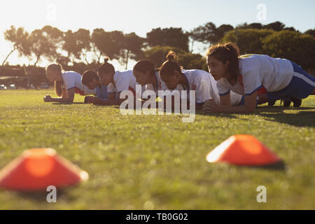 Team of female soccer players working out on the sports field Stock Photo