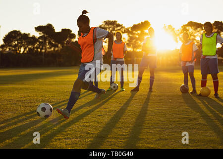 Soccer players playing in sports field Stock Photo