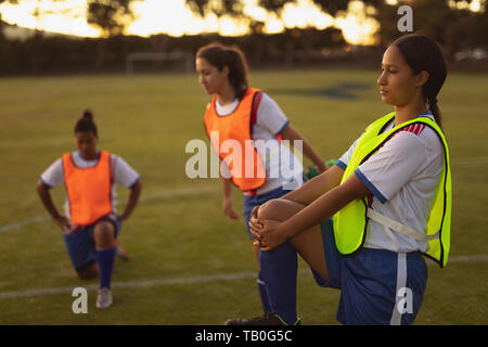 Soccer players doing warm-up exercise in sports field Stock Photo