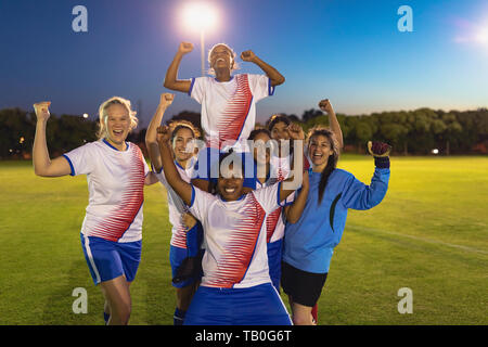 Soccer team cheering on their victory Stock Photo
