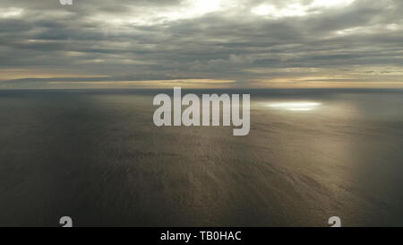 Dramatic sky with clouds over the sea during sunset in cloudy weather, aerial view. Sunset over ocean. Seascape, Summer and travel vacation concept Stock Photo