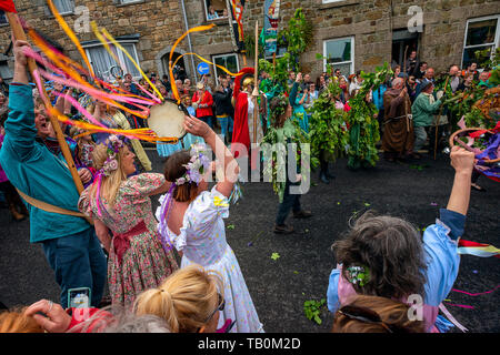 Editorial: Unknown members of the public, potential logo and other trademarks. Helston, Cornwall, UK. Dancers make their way through the streets of He Stock Photo