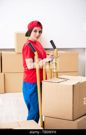 Young female professional mover doing home relocation Stock Photo