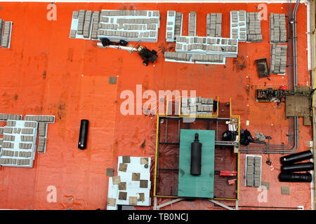Boxes, pipes and other clutter on the orange roof of a building in downtown Chicago, Illinois USA Stock Photo