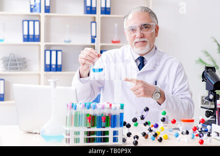 Old male chemist working in the lab Stock Photo