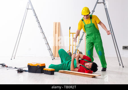 Injured worker and his workmate Stock Photo