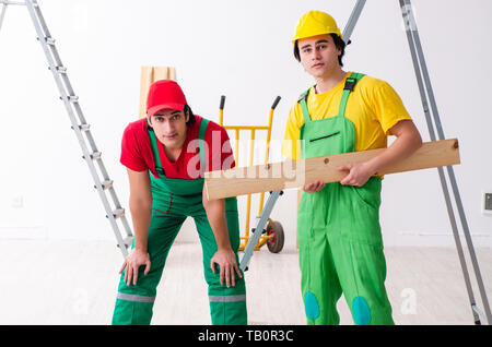 Two workers contractors working indoors Stock Photo