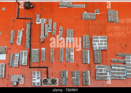 Boxes, pipes and other clutter on the orange roof of a building in downtown Chicago, Illinois USA Stock Photo
