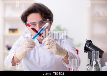 Young male biochemist working in the lab Stock Photo