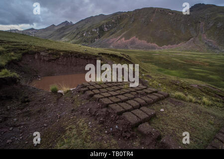 Mud bricks lay in the sun drying so that they can be used for construction in a nearby high Andean village in Peru. Stock Photo
