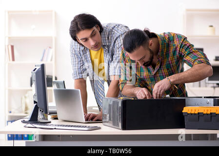 IT engineers working on hardware issue Stock Photo