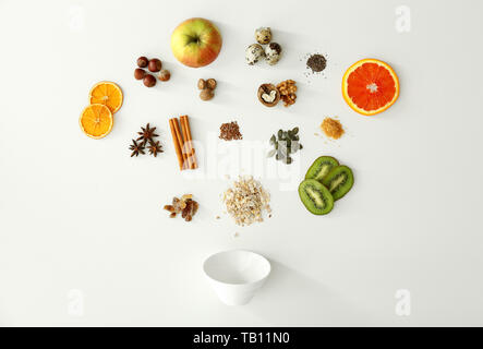 Raw oatmeal, fruits and spices on white background Stock Photo