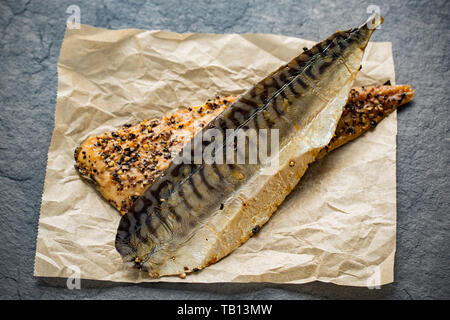 Two Scottish hot smoked mackerel fillets, S. scombrus, with cracked black pepper bought from a supermarket in the UK. Mackerel are a source of Ome Stock Photo