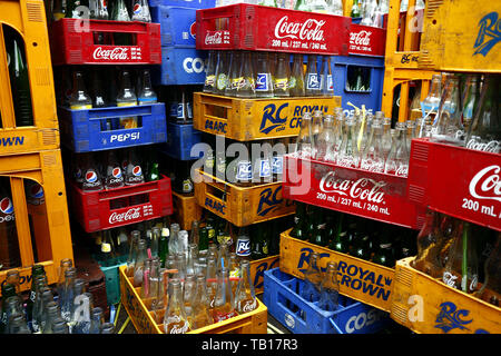 ANTIPOLO CITY, PHILIPPINES - MAY 21, 2019: Stacks of empty soft drinks or soda bottle in their cases at a warehouse. Stock Photo