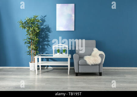 Soft Armchair With Table Near Color Wall In Living Room Stock Photo Alamy