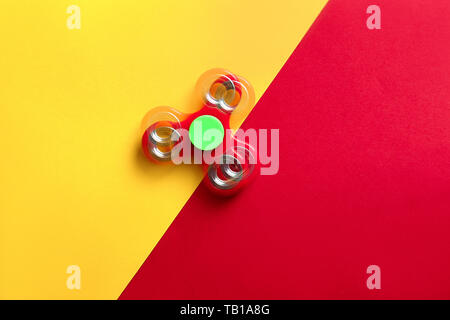 Stroboscopic photo of moving spinner on color background Stock Photo