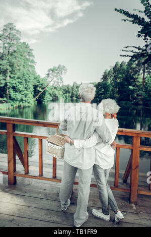 Full-sized picture of couple hugging and enjoying the beautiful scenery Stock Photo
