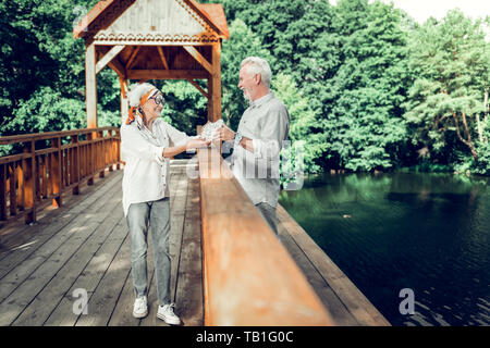 Beaming husband and wife holding a heart sign in hands Stock Photo