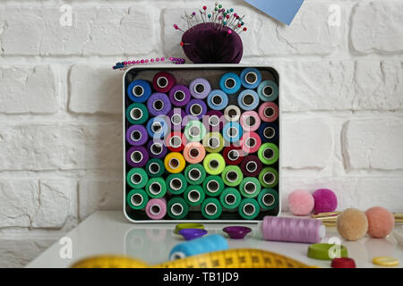 Thread with accessories on tailor's workplace in atelier Stock Photo