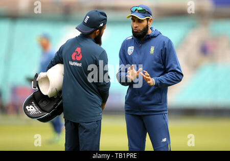 England's Adil Rashid (left) and South Africa's Imran Tahir in discussion during a training session at The Oval, London. Stock Photo