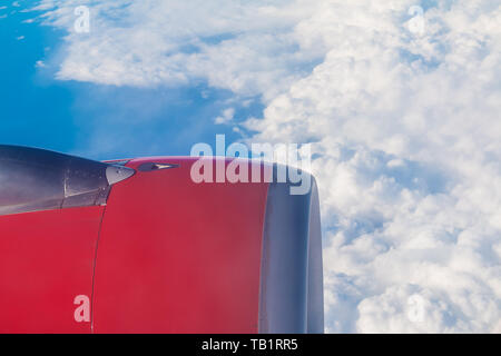 The turbine of the airplane above the clouds closeup, view from the porthole Stock Photo