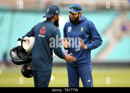 England's Adil Rashid (left) and South Africa's Imran Tahir in discussion during a training session at The Oval, London. Stock Photo