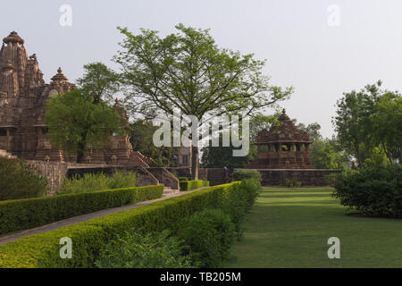Dramatic tree among Khajuraho temples with no people in Madhya Pradesh India Stock Photo
