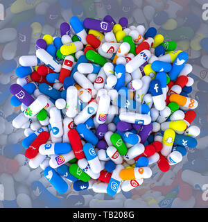 Milan, Italy - May 29, 2019: Pills of various types and sizes in a bottle bearing the logo of the most famous social networks. 3d image render. Editor Stock Photo