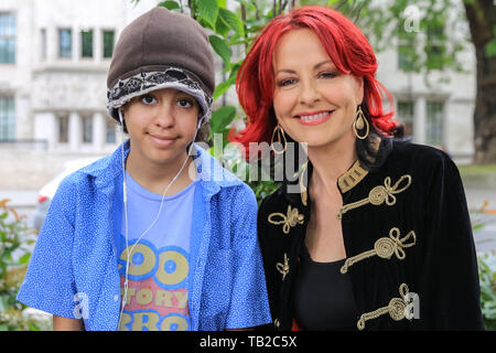 London, UK. 30th May, 2019. TV voice coach Carrie Grant, who has openly talked about raising her own special needs children, supports the protest with one of her children. Hundreds of parents, carers, pupils and young people with disabilities protest in Westminster to highlight a funding crisis in Special Education Needs and Disabilities (SEND). SEND National Crisis, a campaign group deliver a petition to Downing Street before joining the protest. 25 other locations around the country stage similar events. Credit: Imageplotter/Alamy Live News Stock Photo