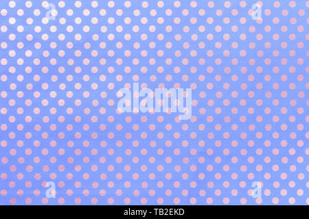 Light blue background from wrapping paper with a pattern of silver polka dot closeup. Texture of holiday dotted paper surface. Backdrop of textile. Stock Photo
