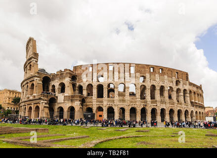 A view of the Coliseum surrounded by a crowd of tourists wishing to get inside Stock Photo