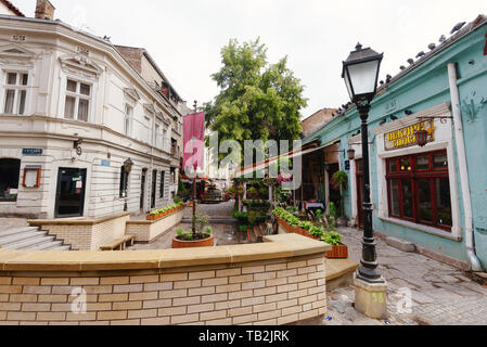 Belgrade, Serbia - June 16, 2018. Historic place Skadarlija with bakery, lamppost, flowers, cobbled lanes and alleys in downtown. Bohemian street with Stock Photo